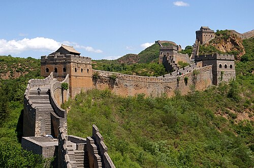 Great Wall of China winding over green hills