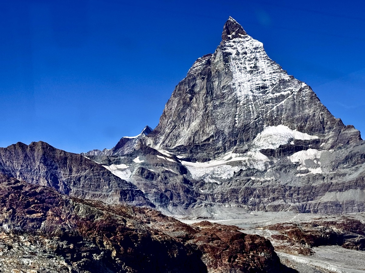 Snow-capped pyramid mountain under clear blue sky