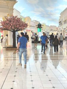 People walking in indoor shopping mall corridor