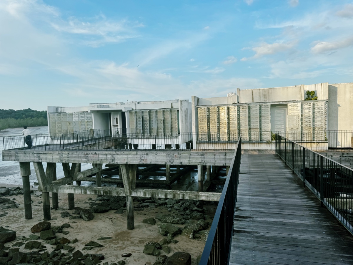 Wooden walkway to stilted concrete waterside structure